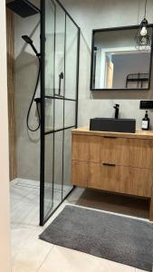 a bathroom with a sink and a mirror at Przytulny Apartament, self check-in, blisko lotniska in Trzebownisko