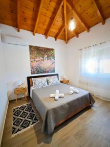a bedroom with a bed with two towels on it at Mandilaria stone house in Afantou +21 photos