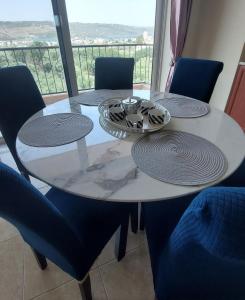 a dining room table with chairs and a table with a view at Souda Bay View Retreat in Souda +4 photos