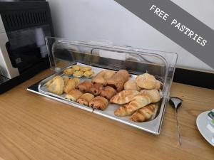 a tray of pastries and other pastries on a counter at Porto Velho Boutique Lodge in Madalena