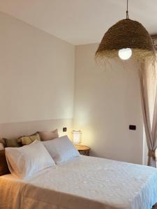 a bedroom with a bed with a wreath hanging from the ceiling at Dimora da Adele in Termoli +24 photos