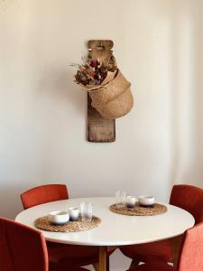 a white table with chairs and a vase with candles at Dimora da Adele in Termoli