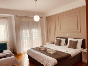 a bedroom with a large bed with two pillows on it at Front Beach Exclusive Apartments in Struga
