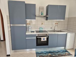 a kitchen with a sink and a refrigerator at Da Gio' e Eli in Sestri Levante