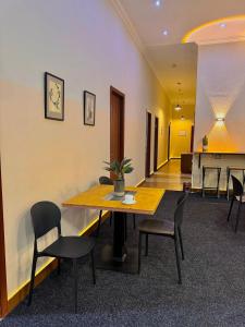 a conference room with a wooden table and chairs at Hotel Aleksandria in Tbilisi City
