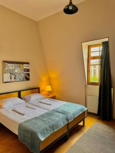 a bedroom with a bed and a window at Hotel Aleksandria in Tbilisi City +44 photos