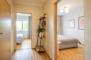 a bedroom with a bed and a room with a window at Aardla Cozy Apartment in Tartu