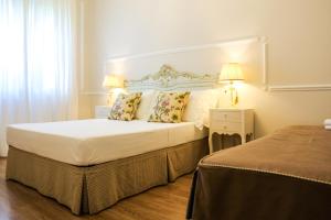 Postel nebo postele na pokoji v ubytování B&B Le Bianche