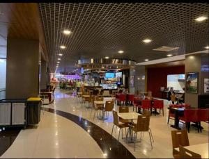 a restaurant with tables and chairs in a mall at Vip Apartment Center in Baku +17 photos