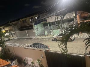 a dog laying on the balcony of a building at night at Casa para alugar em Salvador in Salvador