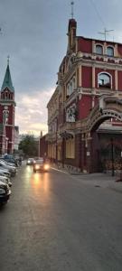 a city street with cars parked in front of buildings at No work in Ivišovo Greblje