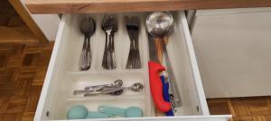a drawer filled with utensils in a cabinet at No work in Ivišovo Greblje