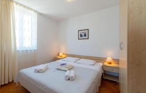 Posteľ alebo postele v izbe v ubytovaní Apartments Tamarix