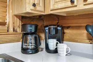 a coffee maker and coffee cups on a kitchen counter at Your Getaway Oasis in Sevierville