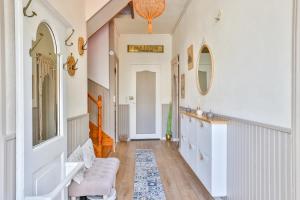 a hallway of a home with white walls and wooden floors at Maison 5 chambres #10 personnes #Jardin in Cognac +58 photos