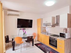 a kitchen with a table and chairs and a microwave at Guesthouse Korzo in Rijeka