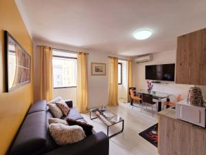 a living room with a couch and a table at Guesthouse Korzo in Rijeka