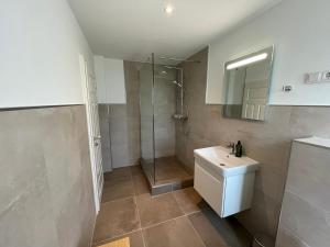 a bathroom with a shower and a sink and a toilet at Inselglück Gerdina in Norddorf +57 photos