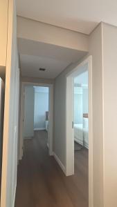 an empty room with a bed and an open door at Apartamento TOP - No Praia Brava Hotel in Florianópolis +7 photos