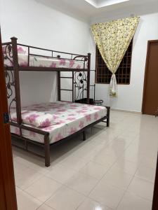 a bedroom with two bunk beds and a window at Bidor Homestay in Bidur