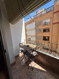 a balcony with a table and chairs on a building at The Ruzafa by Laura - AVE in Valencia
