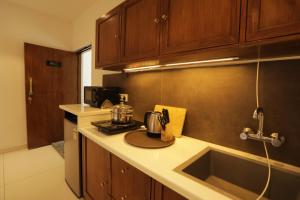 a kitchen with a sink and a counter top at Bangalore Hideaway 1BHK Spanish villa Casa Rio in Denkanikota +13 photos