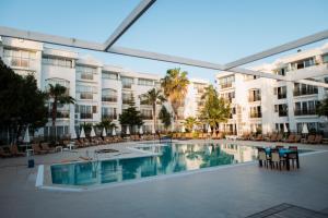 a view of the pool at a resort with tables and chairs at Club Golf Hotel All Inclusive in Side