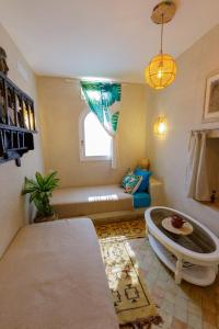 a living room with a couch and a table at Dar Okinawa near Taghazout - Peaceful getaway and surf in Taghazout