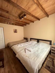 a bedroom with two beds and a wooden ceiling at Mardoyan's Guest house in Gavarr