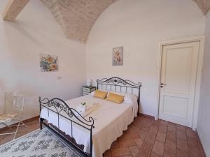 a bedroom with a bed in a white room at A casa di Carmen in Modica
