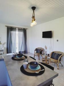 a living room with two bowls on a table at Giorgos concept suites AGAPI in Edipsos
