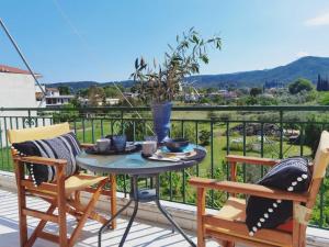 a table and chairs on a balcony with a view at Giorgos concept suites AGAPI in Edipsos