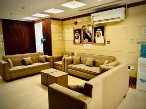 a waiting room with couches and tables in a room at Hotel Chatha Manoura- in Medina