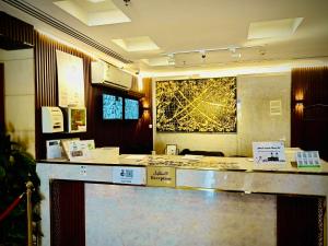 a counter in a room with a painting on the wall at Hotel Chatha Manoura- in Medina