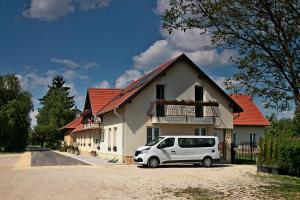 a white van parked in front of a house at Rembrandt Vendégház in Kisbér