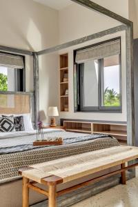 a bedroom with a large bed and two windows at Villa Reverie By AT Villas in Vagator +84 photos