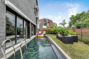 a swimming pool in the backyard of a house at Villa Reverie By AT Villas in Vagator
