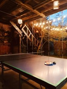 a ping pong table in the middle of a room at Cabaña en la Calera BersaNina in La Calera