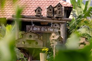 a bird house with a sign on it at Scenic Mountain Ecolodge Ninh Binh in Ninh Binh