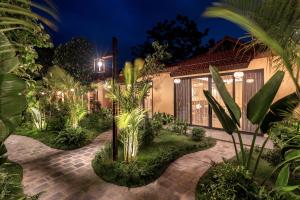 a house with a lot of plants in front of it at Scenic Mountain Ecolodge Ninh Binh in Ninh Binh +129 photos