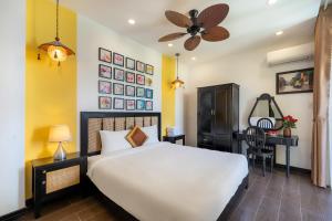 a bedroom with a large white bed and a desk at Hoi An 2BR private Pool Villa - Walk to Old Town in Hoi An