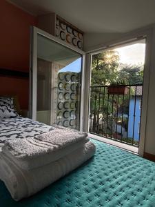 a bedroom with a bed and a large window at Appartamento Nuvola Bianca 2 in Cesenatico