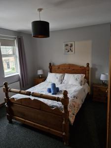 a bedroom with a large bed with a wooden frame at The Yellow Door in Seapatrick