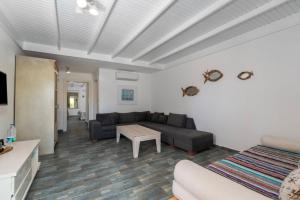 a living room with a couch and a table at Kefi Beach & Suites in Ortakent