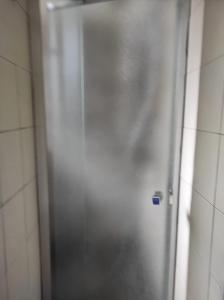 a silver shower door in a tiled bathroom at Green Art Studios in Rome