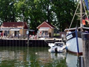 a boat is docked at a dock with a restaurant at Ferienwohnung 105 Haus Katharina mit Balkon in Lauterbach