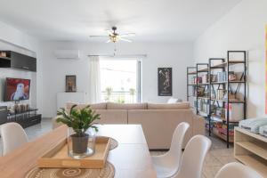 a living room with a couch and a table at Island Memories Apartment in Ampavris