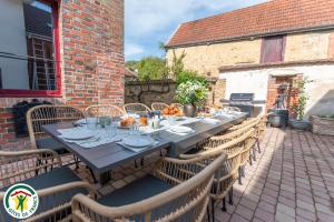 a long table with chairs on a patio at Prelude Hautvillers in Hautvillers