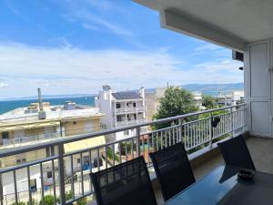 a balcony with a table and chairs and a view at Aphrodite Sea View Apartment in Perea