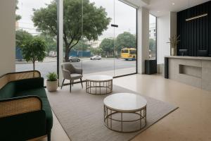 a living room with two tables and a couch at QNZ Hotel Jakarta in Jakarta